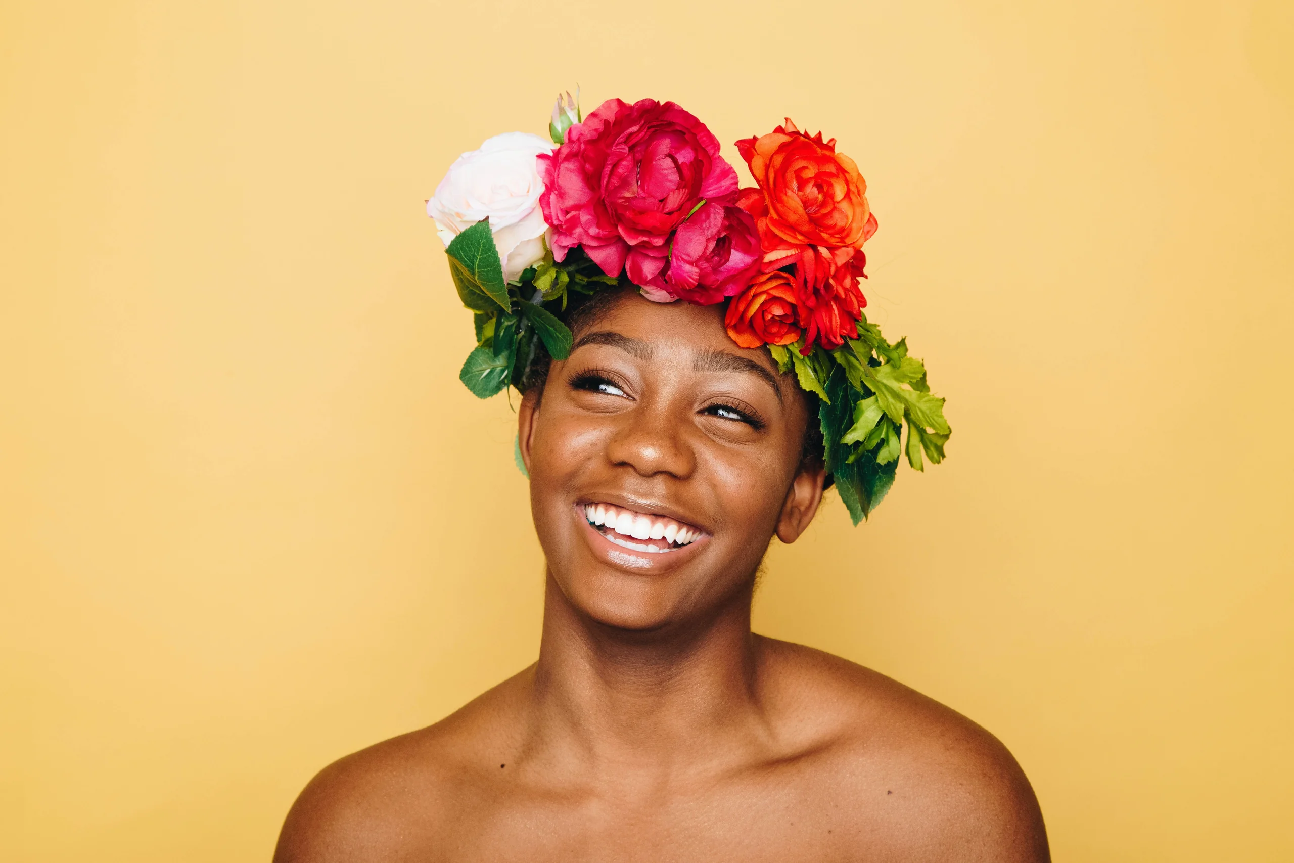 Portrait of a person wearing a floral headpiece