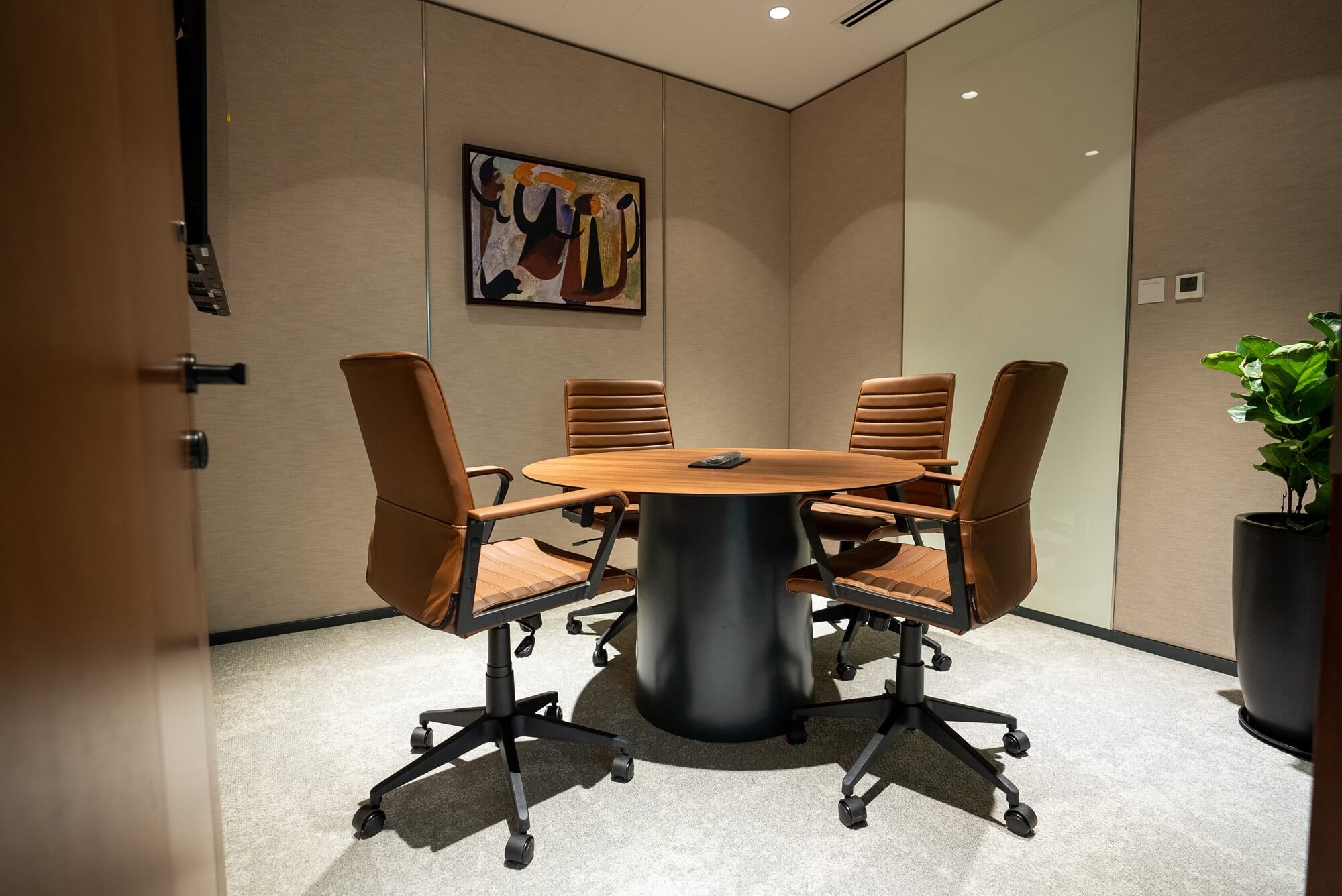 Contemporary 4-seater private meeting rooms with leather chairs for executive use.
