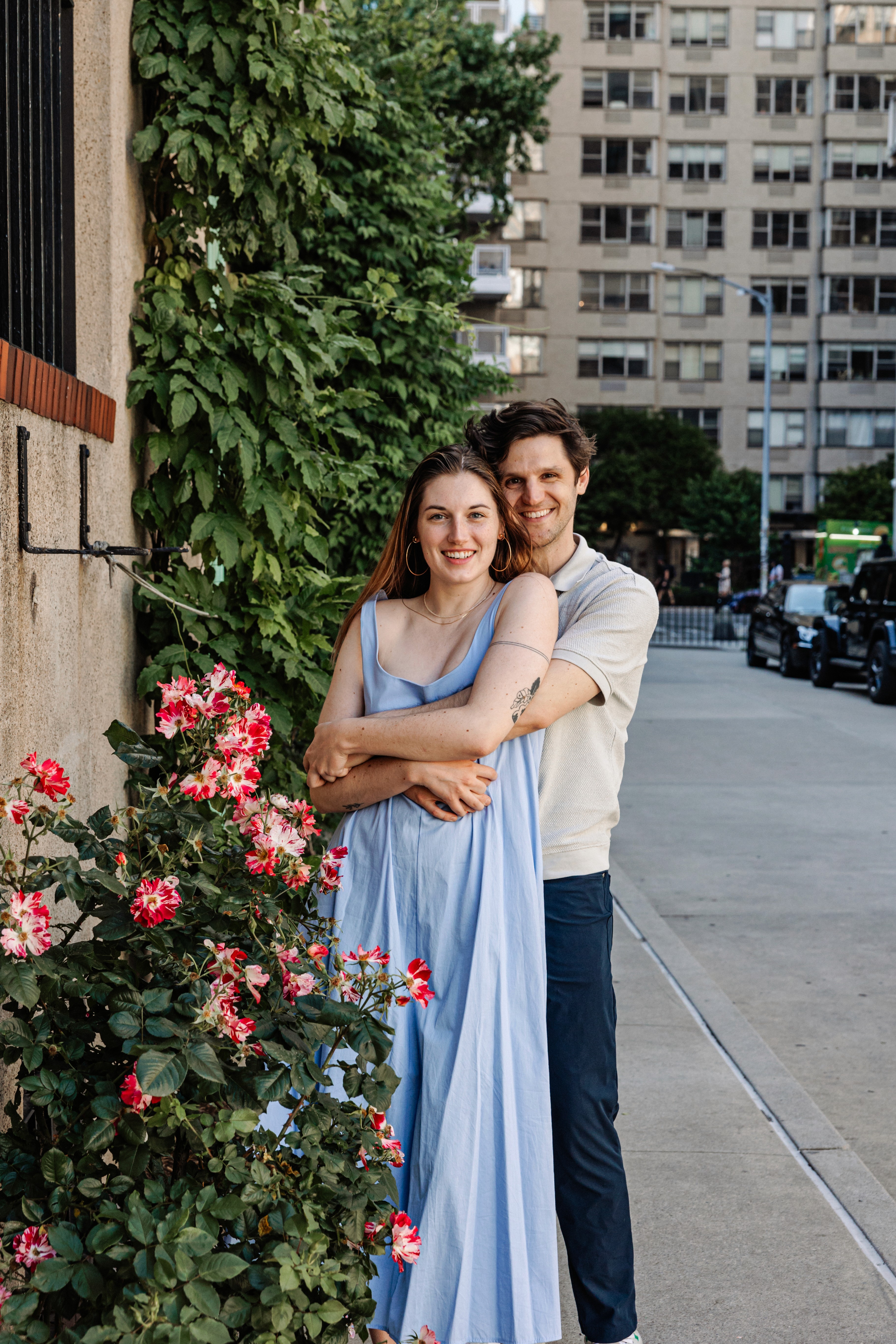 6:13 PMNewly engaged couple sitting on a stoop in the West Village, NYC bathed in warm golden hour light — romantic, candid golden hour engagement photography by Lizz Spano Photography, New York City engagement photographer.