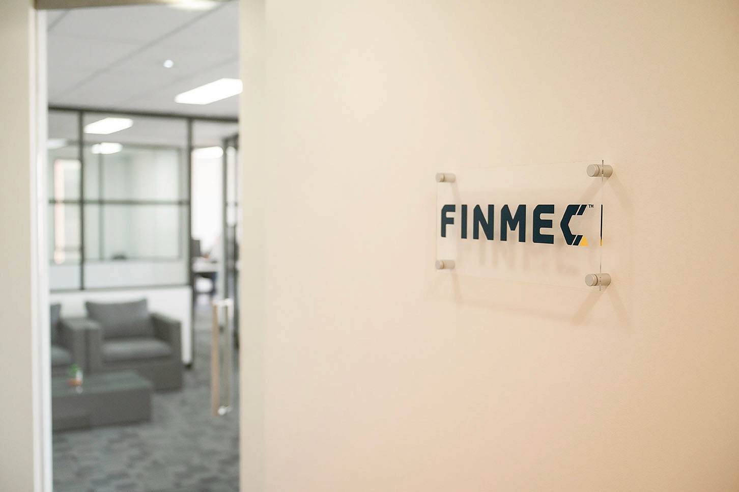 Cluster of translucent pink glass pendant spheres hanging on white—modern lighting décor.