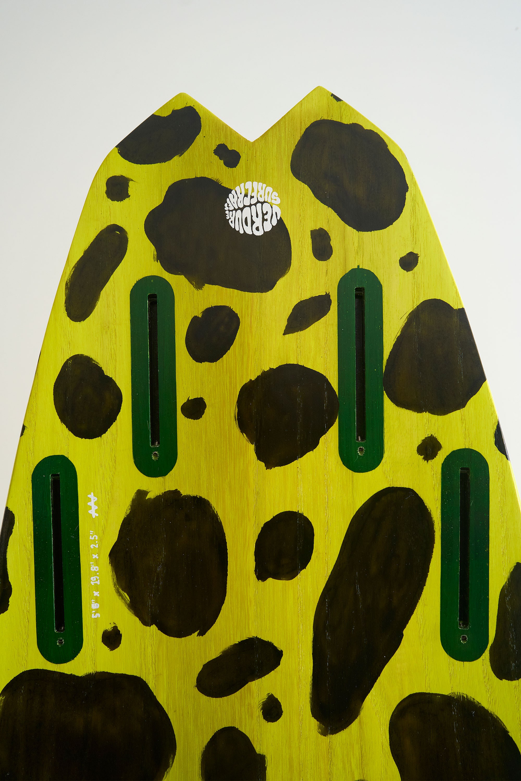 Yellow timber surfboard tail with 4 futures fin boxes