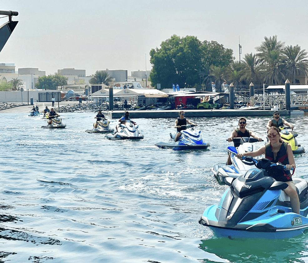 A group of competitors at the start line of a professional jet ski racing event.