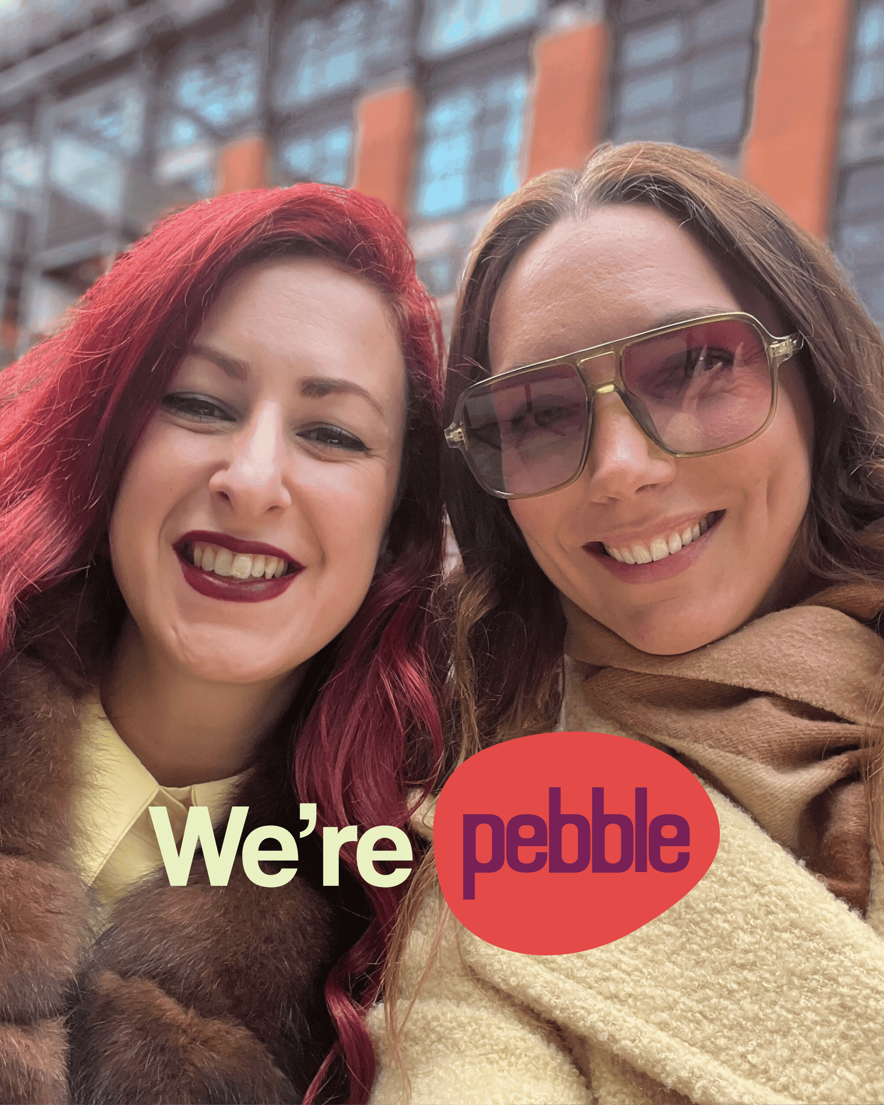 Two women smiling and looking at the camera