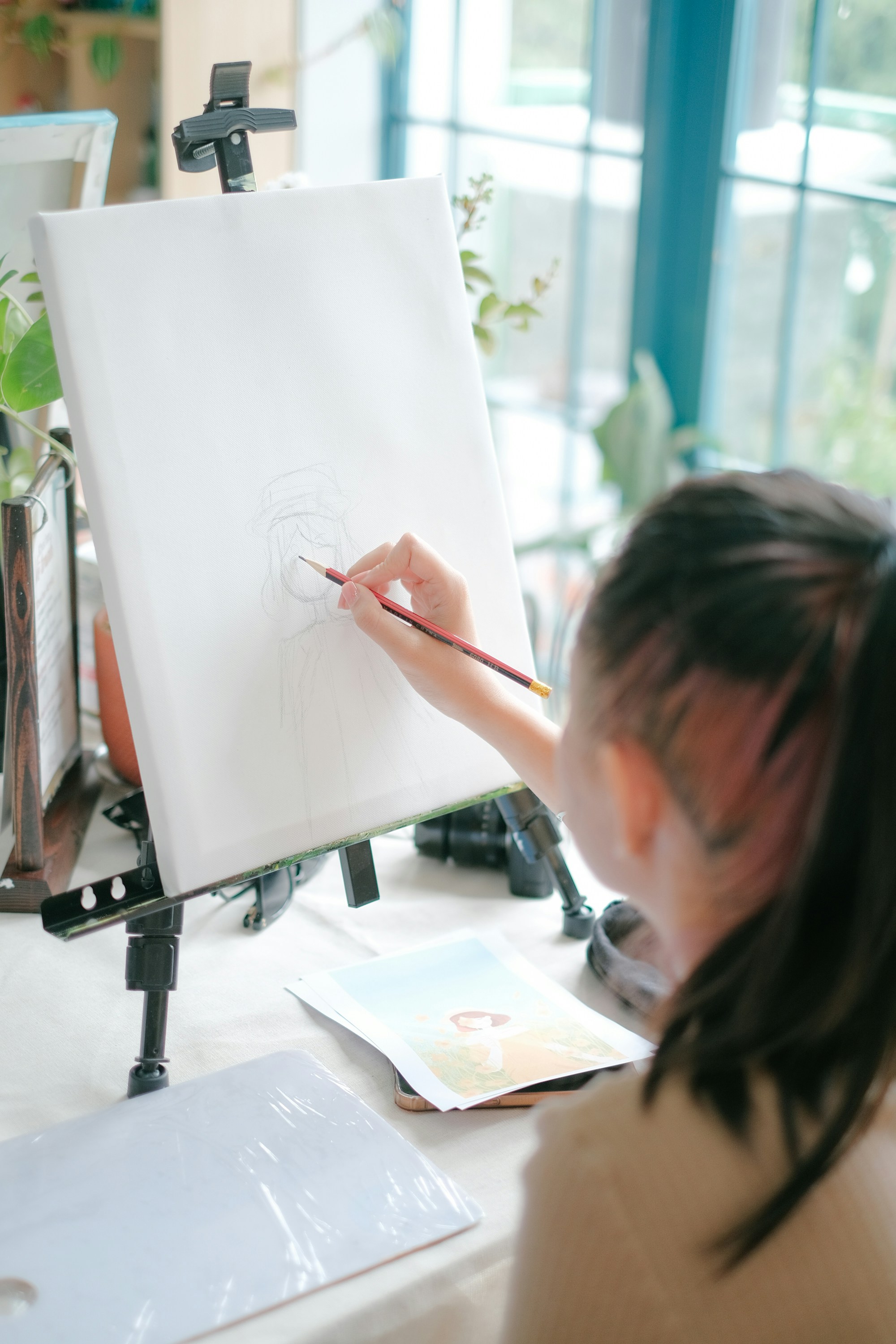 a woman is drawing on a white board