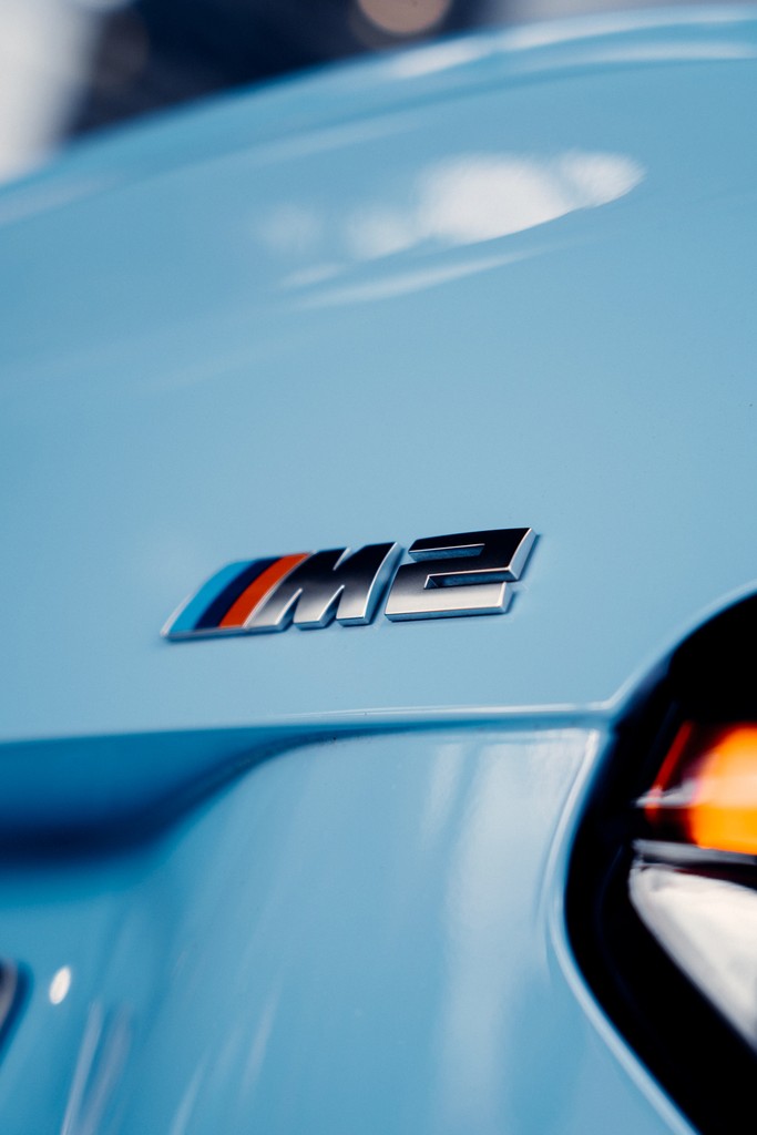 Close-up of BMW M2 logo in baby blue