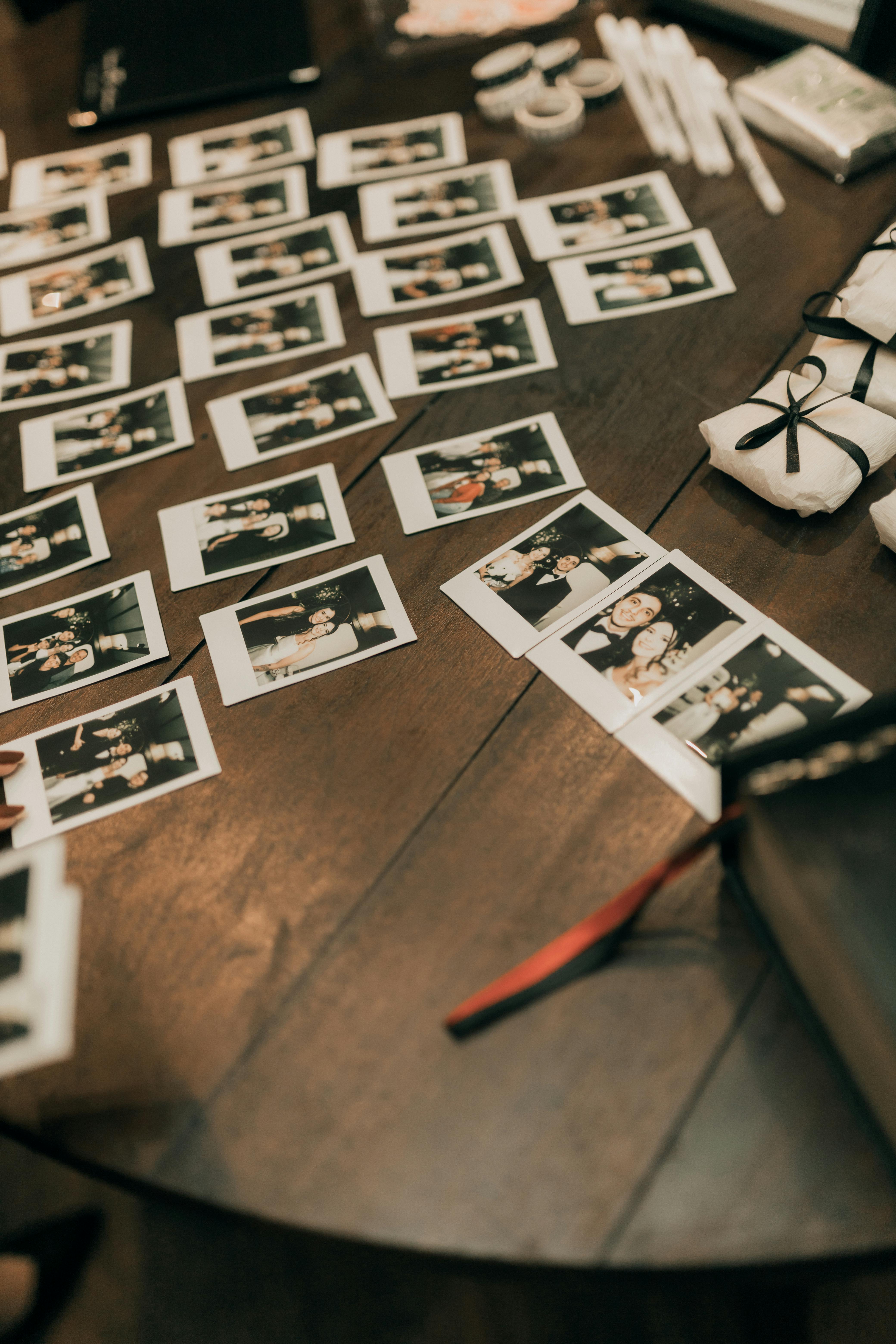 a-decorated-wooden-table-filled-with-instant-photos-capturing-memorable-moments. - alexander-mass (pexels)