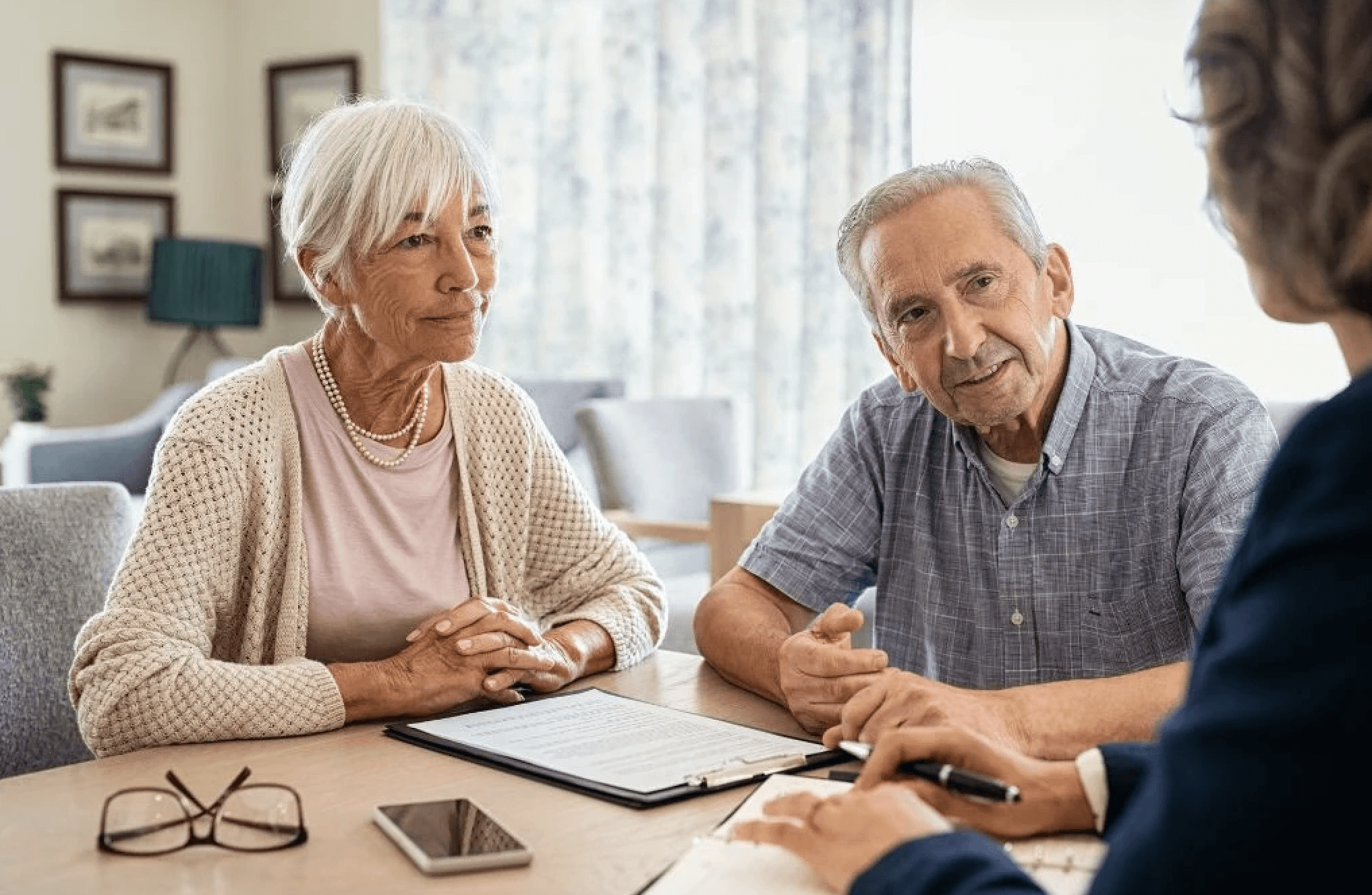 elderly couple listening to advisor
