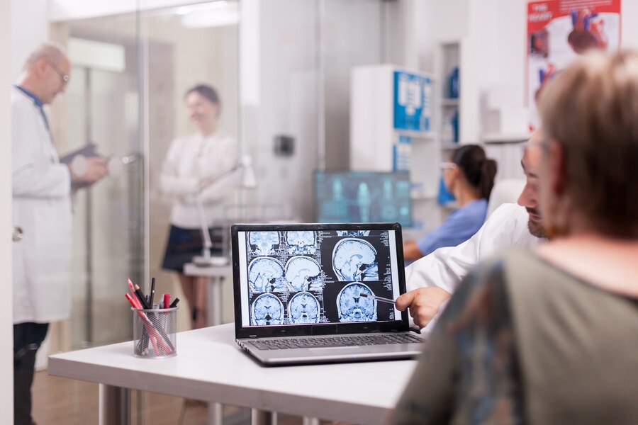 A senior doctor looking at the brain scans of the patient. 