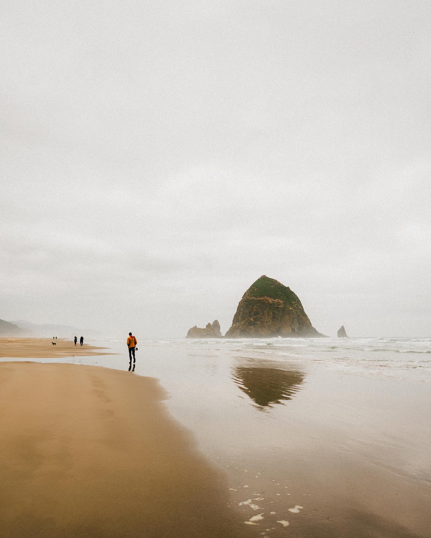A distant view of Haystack Rock on a cloudy day at the Oregon coast.
