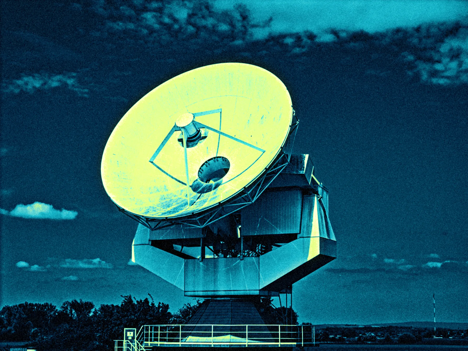 A radio telescope dish in cyan and lime false colour