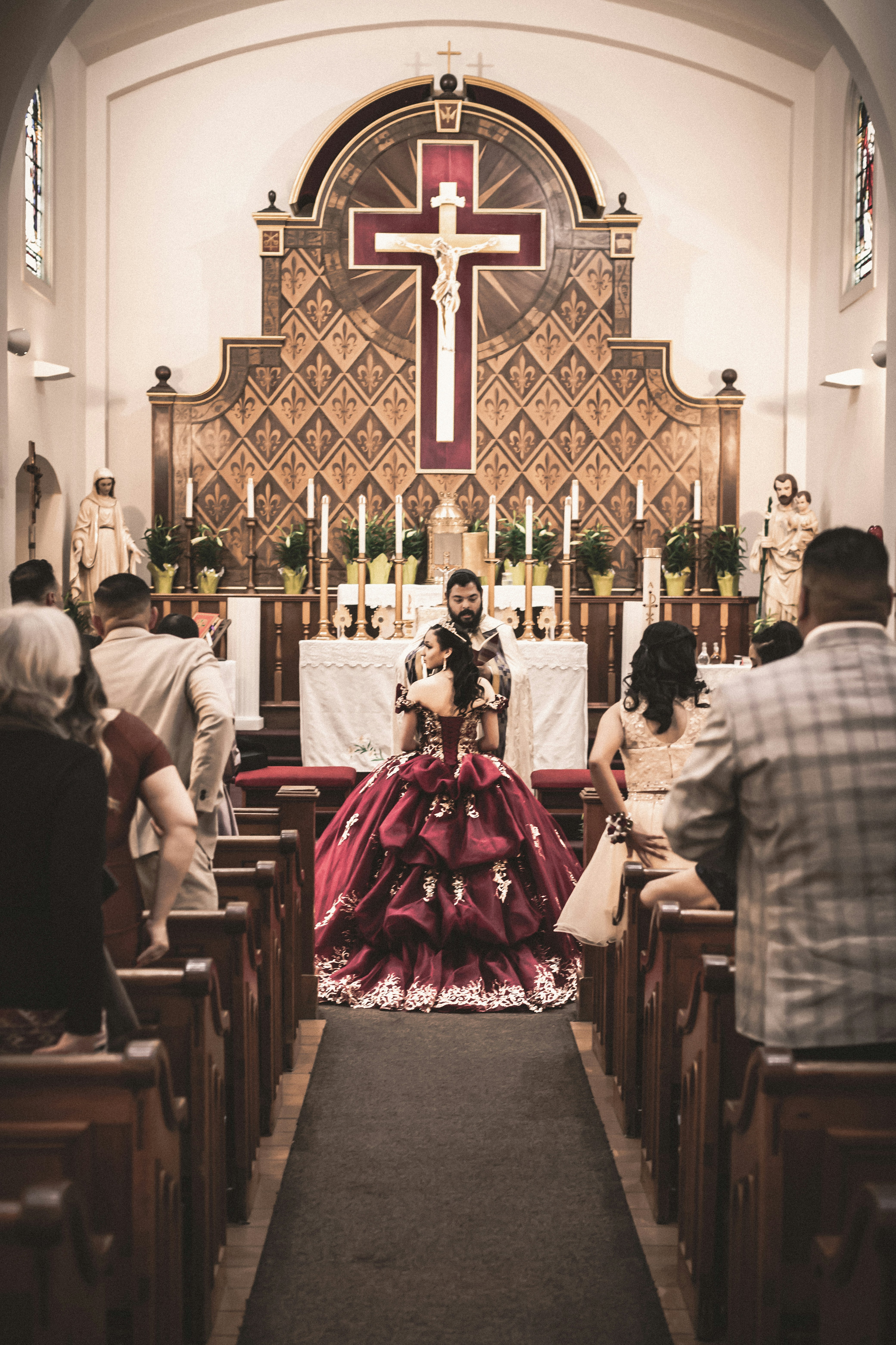 a woman in a red dress sitting in a church