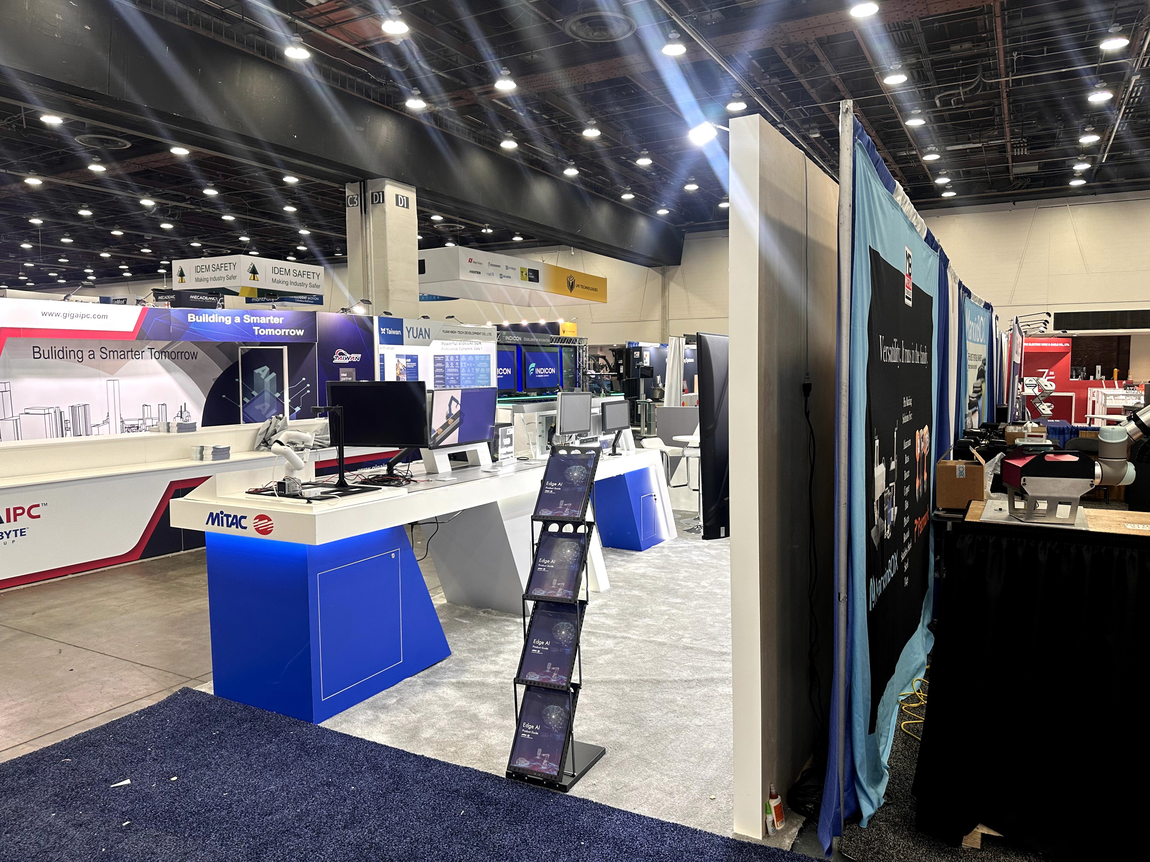 Literature rack and booth entry view for MITAC at Automate 2025 trade show