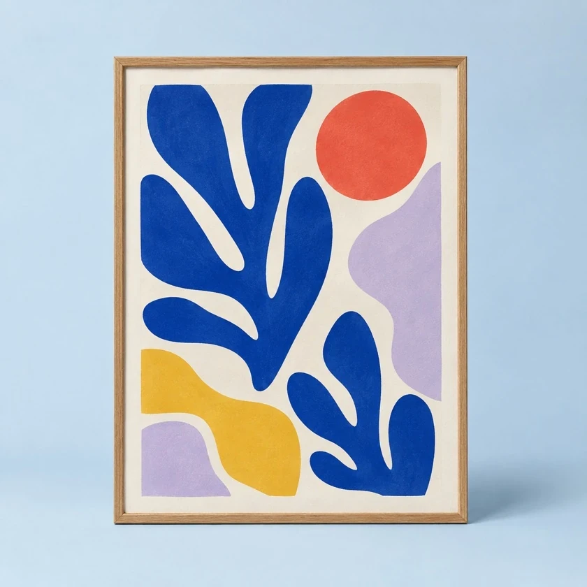 Colourful abstract art print in a complete oak frame on a pale blue backdrop