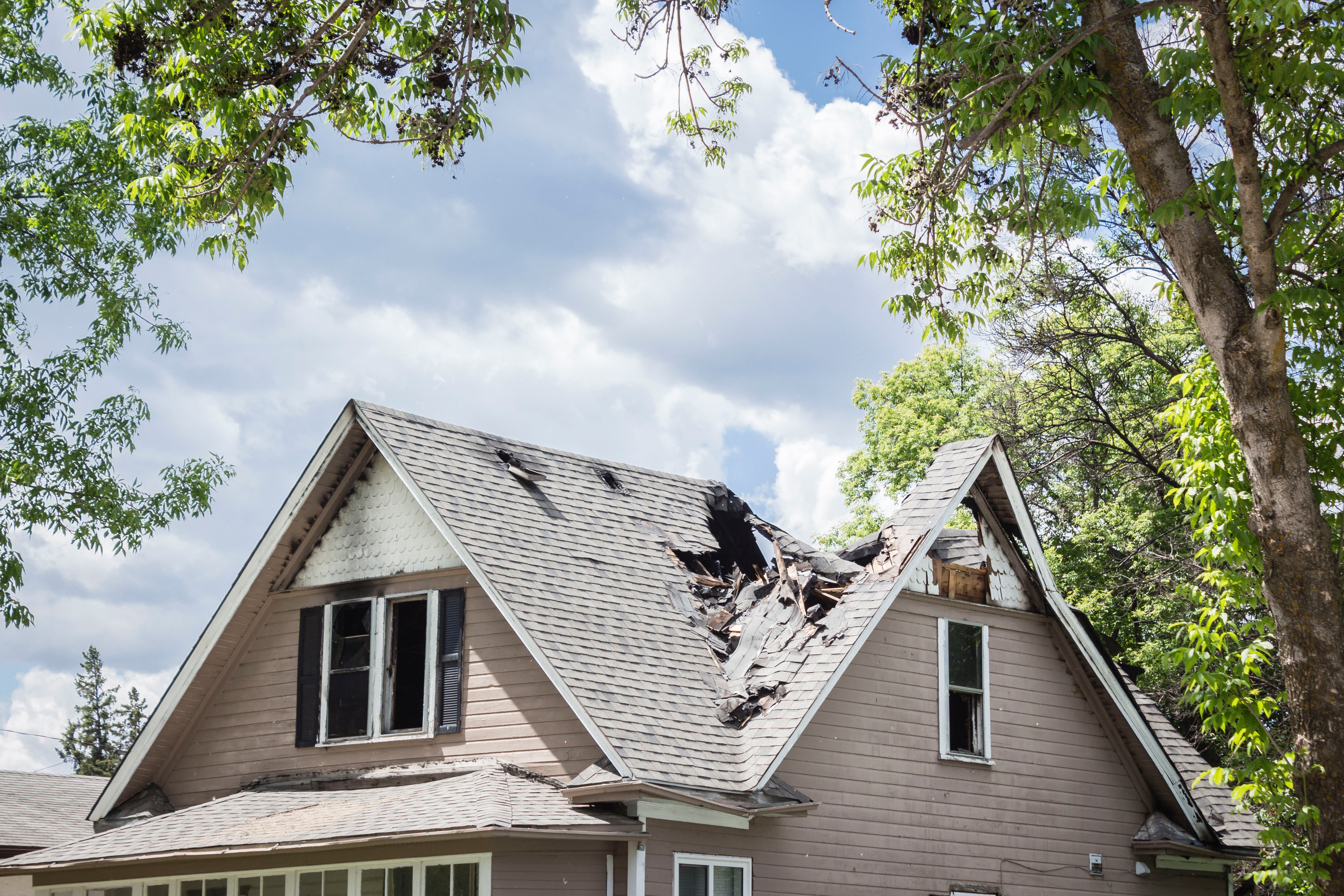 Emergency roof repair St. Louis team responding at night with spotlights and safety equipment to storm damage