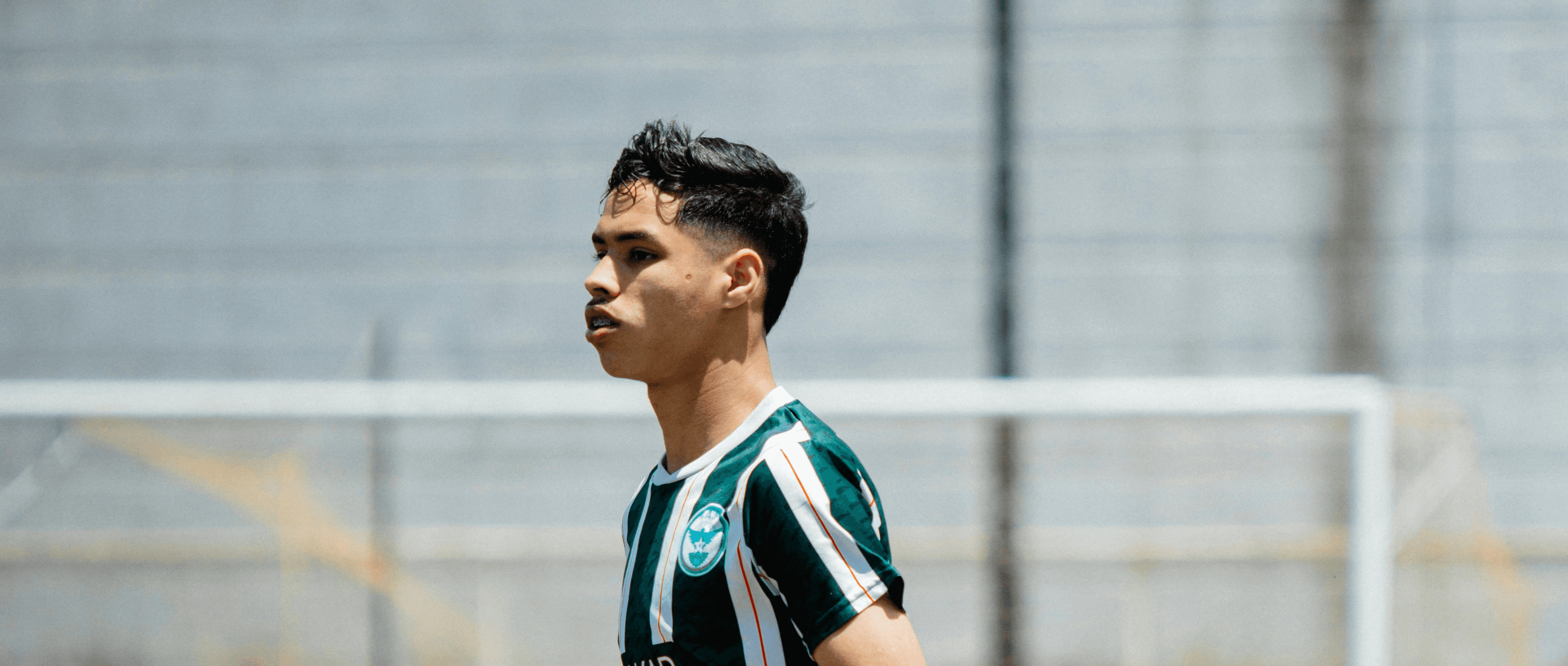 Soccer player is running on the field.