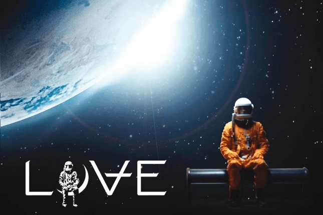 A lone astronaut in an orange suit sits on a platform in space, facing a bright planet. The word "LOVE" is artistically written, incorporating a small astronaut design. The background is a star-filled expanse.