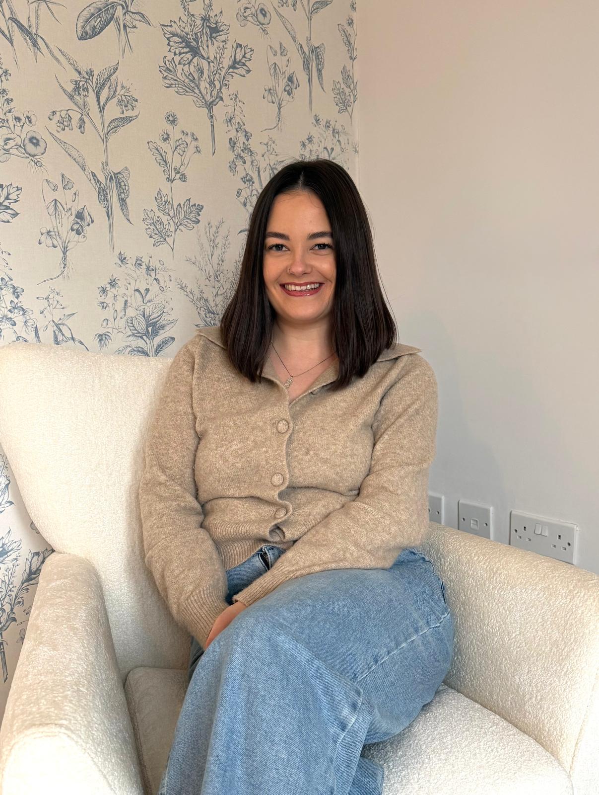 woman in black long sleeve shirt sitting on white couch