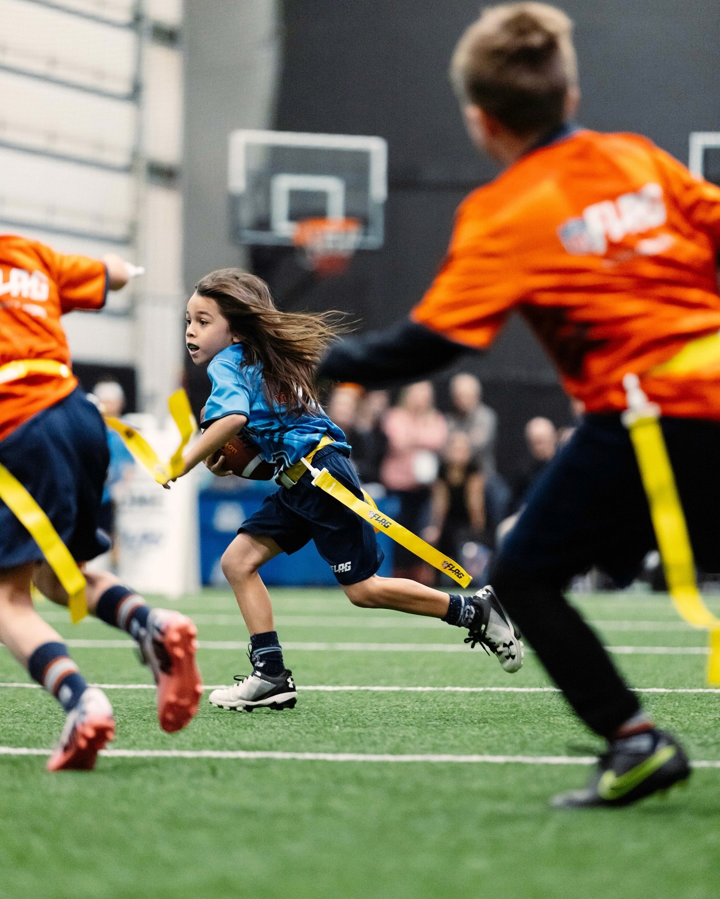 Flag football players competing in an NFL Flag program managed with TeamLinkt