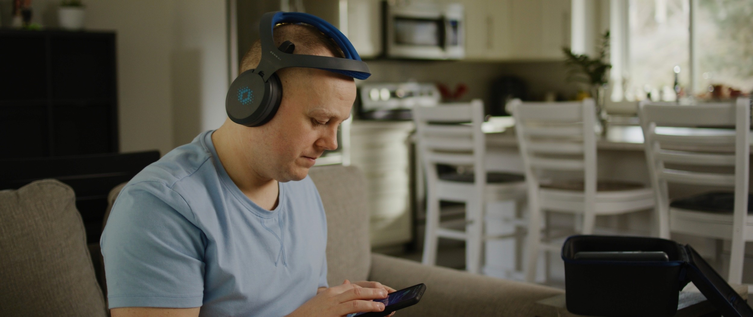 Man wearing headset while looking at smartphone