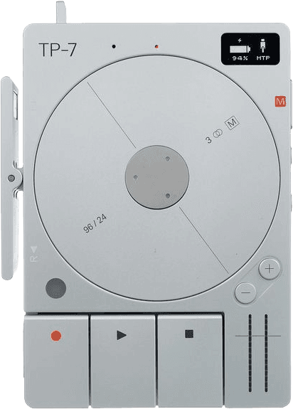 Teenage Engineering TP-7 field recorder, a rounded silver device with a spinning disc, small display reading 94 percent, and transport buttons.