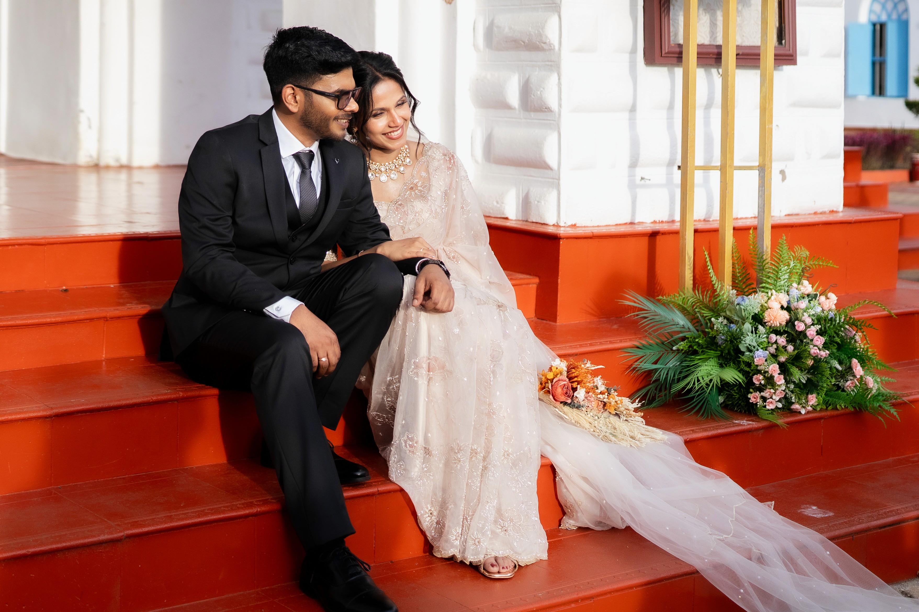 Cozy seating area with vintage chairs and patterned sofa.