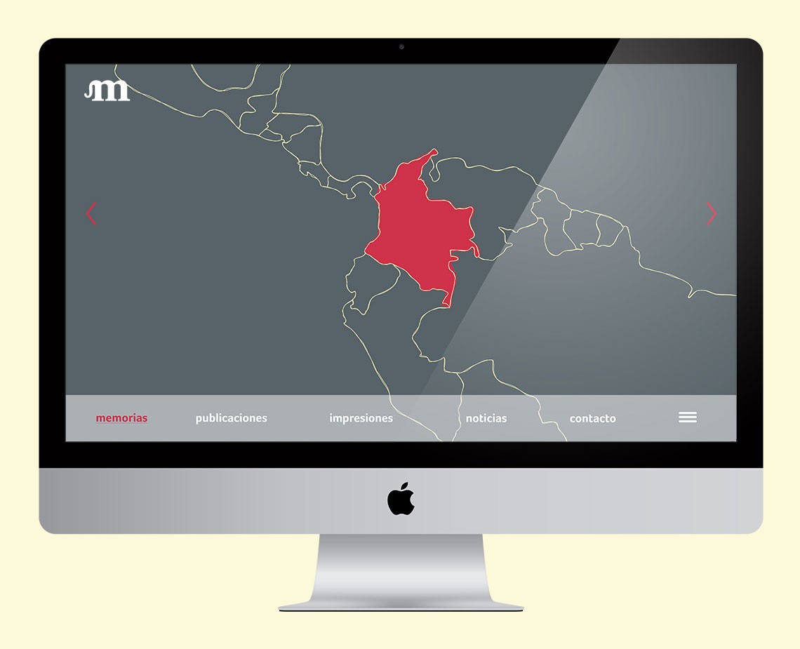 A silver Apple iMac computer displays a map in dark gray on a light yellow background. The map shows a red shape in the central area, outlined in thin yellow lines. Below the map are three navigation tabs: “memorias,” “publicaciones,” and “noticias,” each labeled in white text. To the right is a white menu icon.