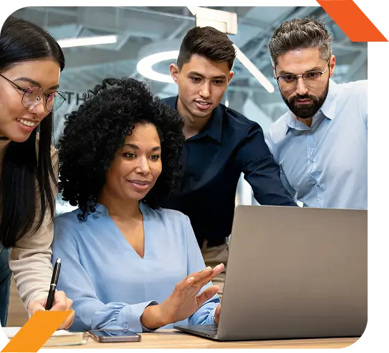Some people looking at a laptop screen with an orange design.
