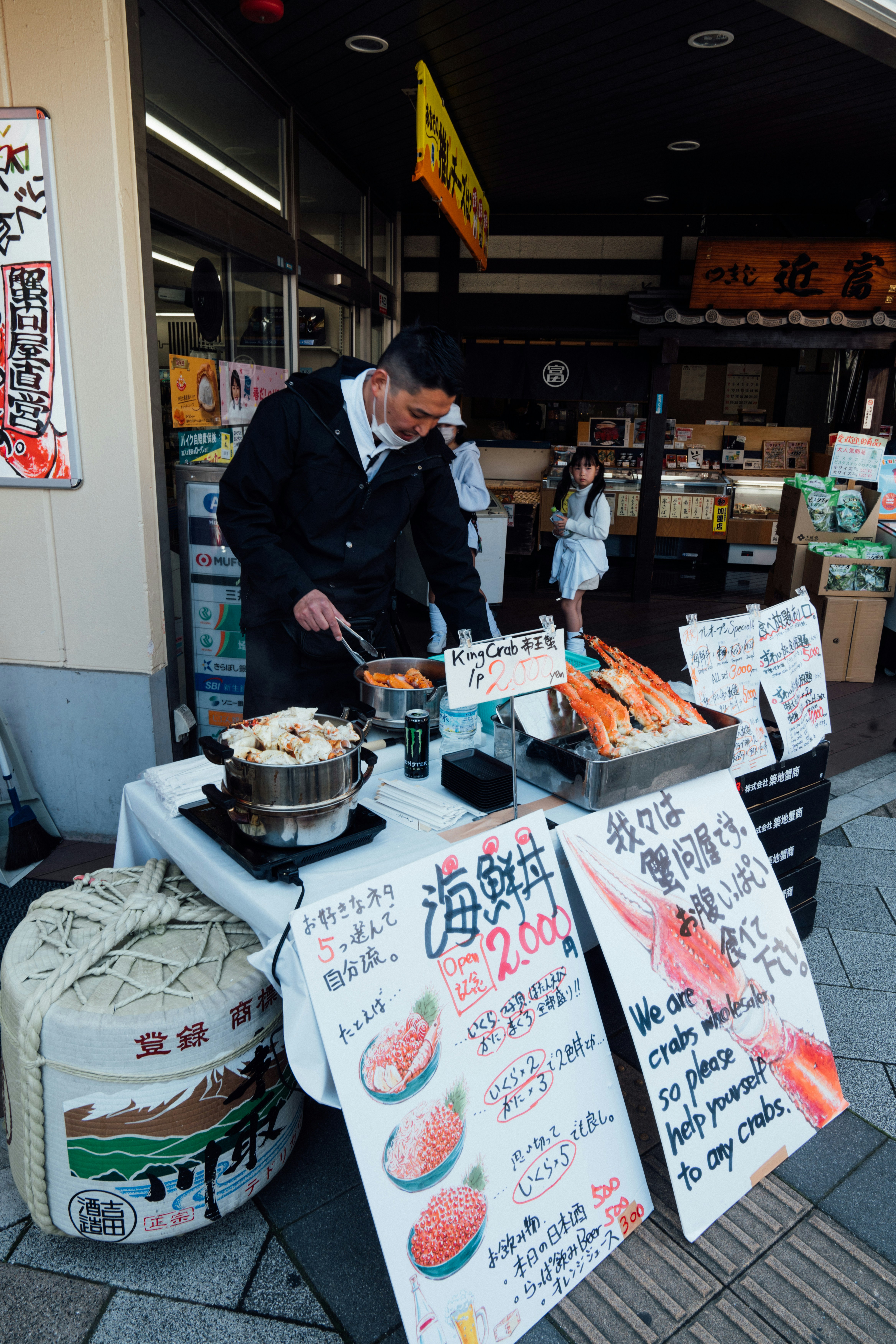 A vendor preparing food at a market stall in Japan