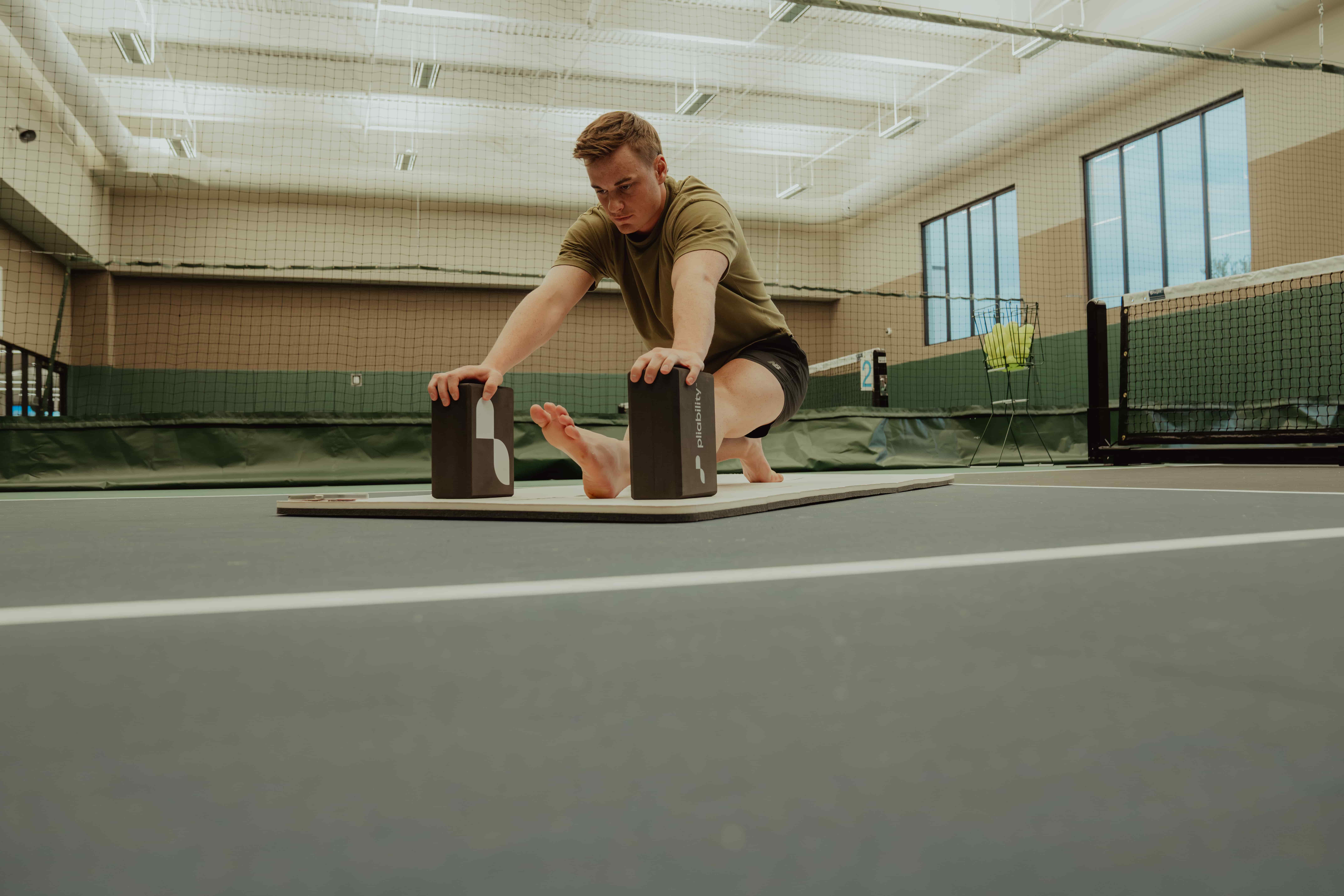 Man Stretching in Gym - Stretch Before Or After Workout