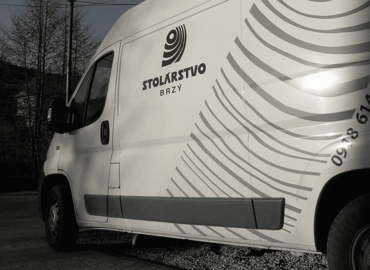 A close-up shot of a company vehicle for Stolárstvo Brzý, featuring the Poleno typeface.