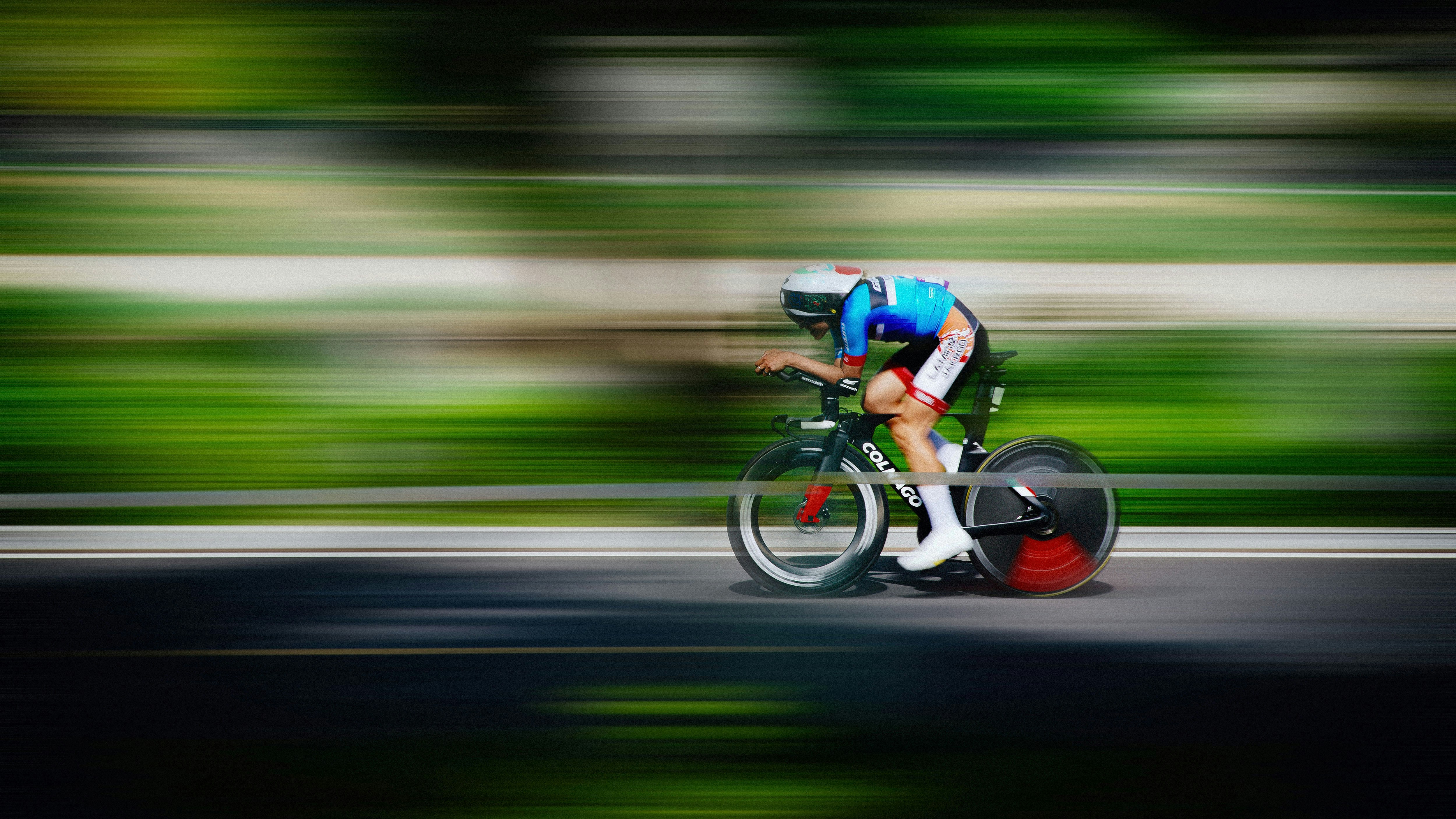 Cyclist racing on a road with motion blur