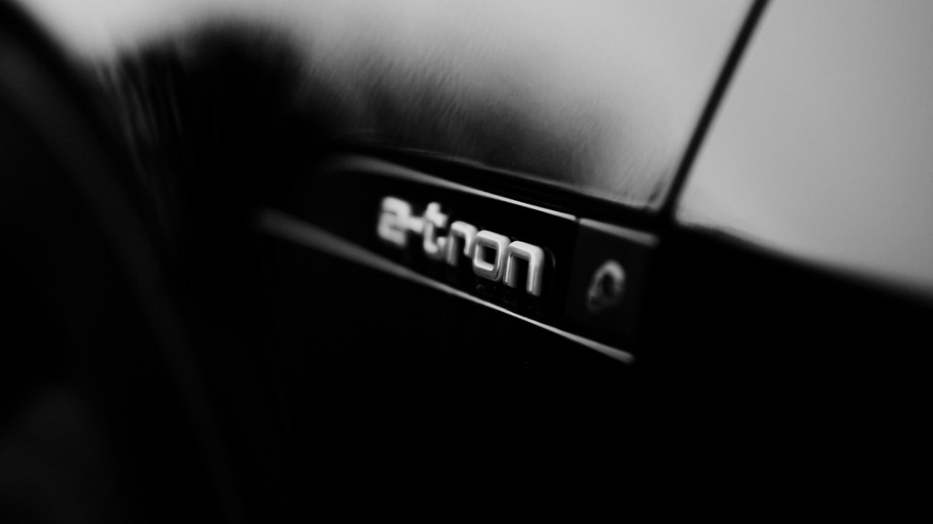 Black-and-white close-up of an Audi emblem