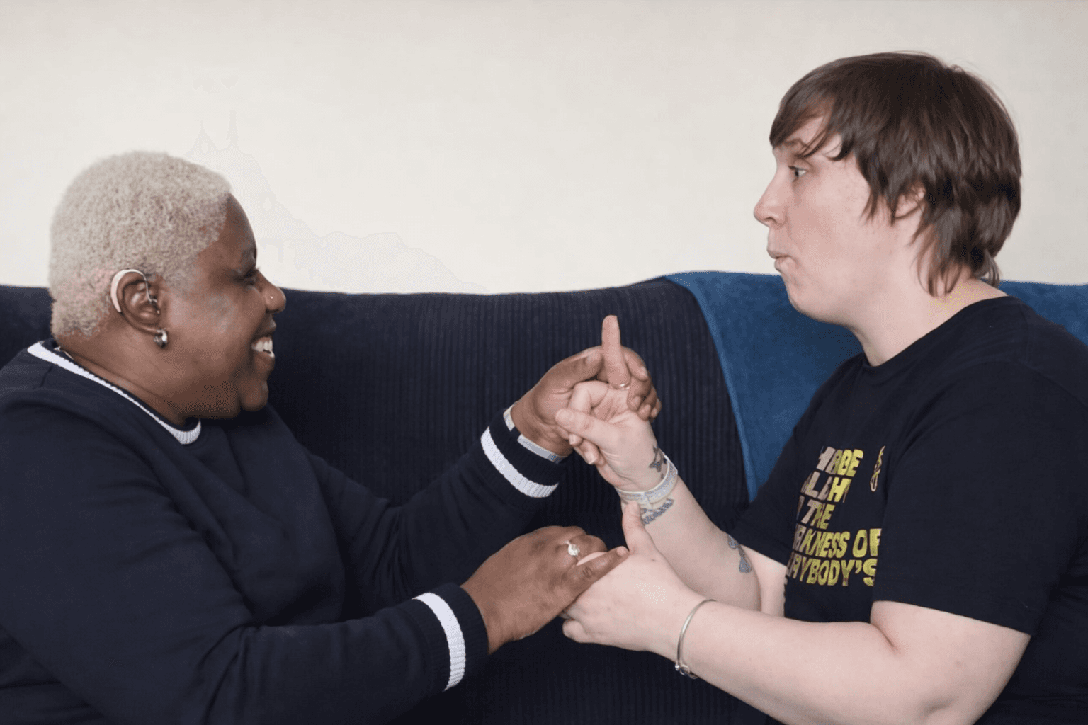a support worker communicating with a deaf blind woman