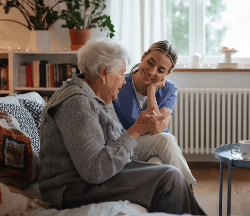 Male caregiver interviewing elderly man with the goal of creating a care plan tailored to his needs.