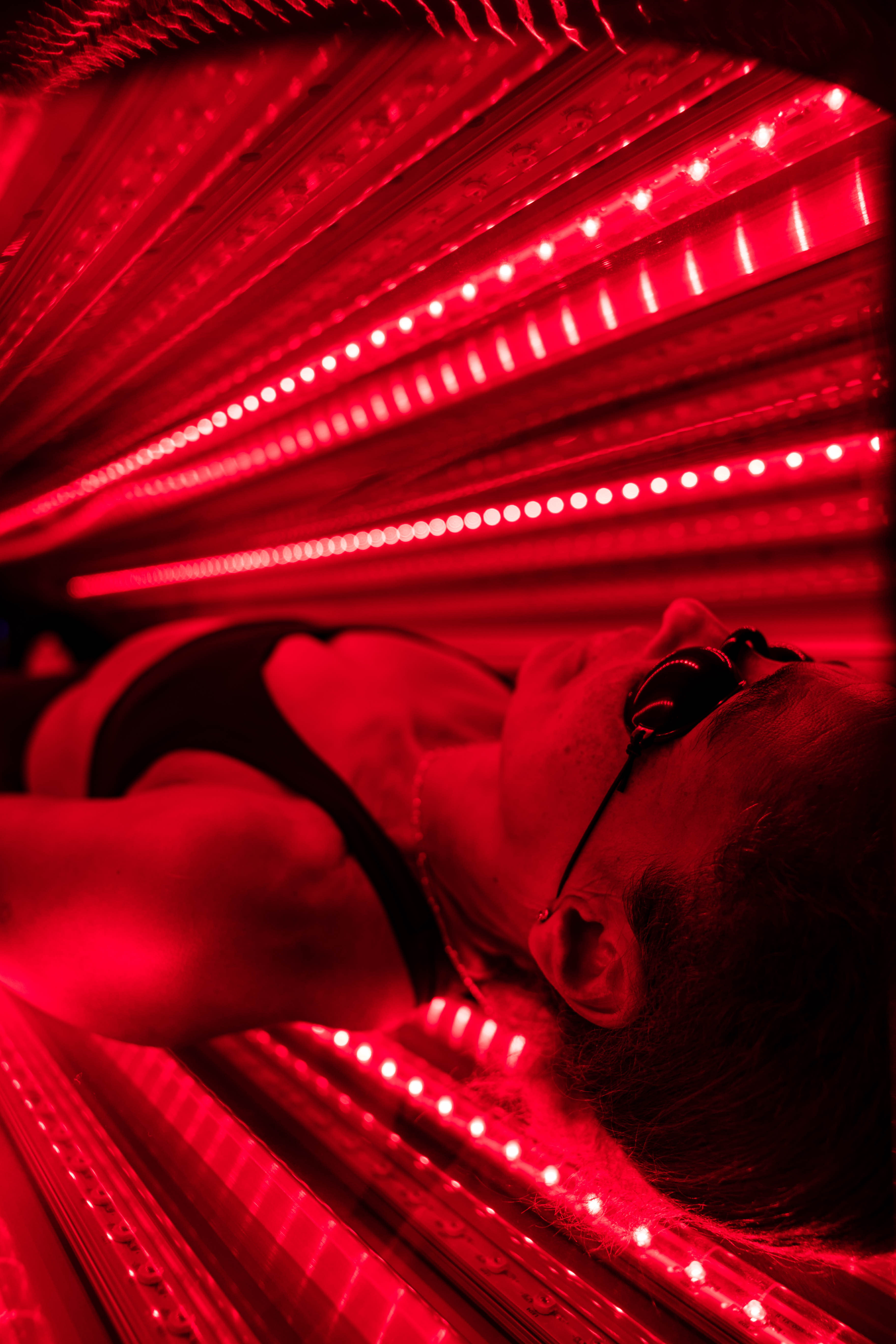 woman in a red light bed