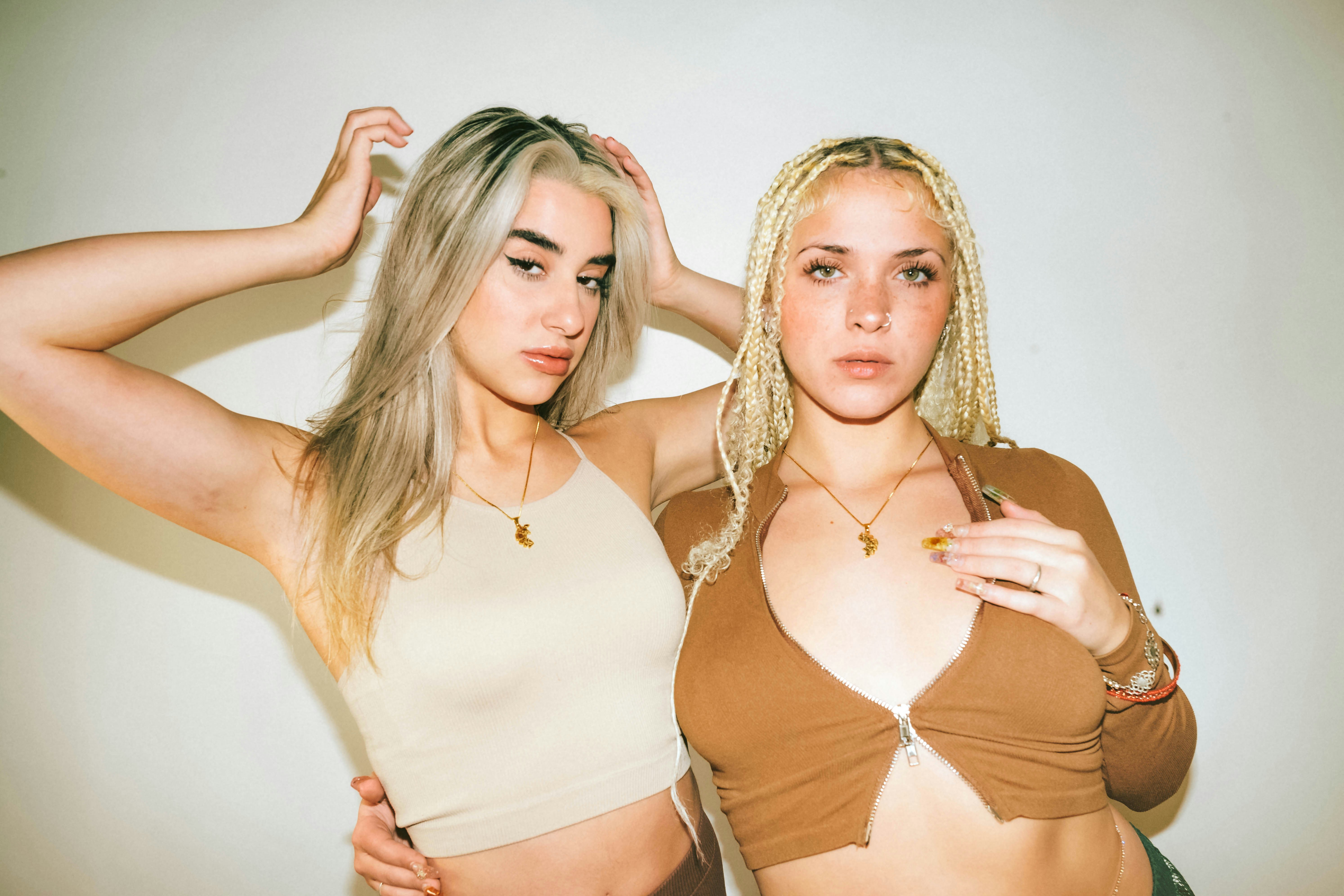 two beautiful young women standing next to each other