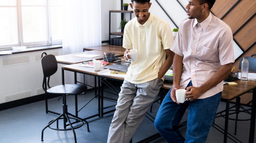 A person wearing a camouflage military uniform sits with hands clasped together, symbolizing strength and solidarity.