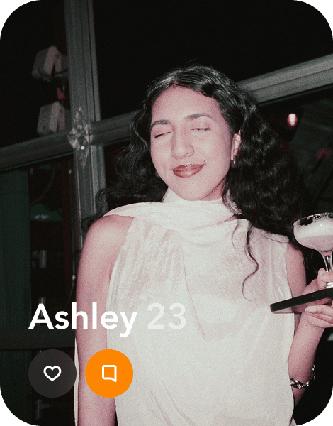 a profile of a young woman smiling with her eyes closed as she holds up a cocktail