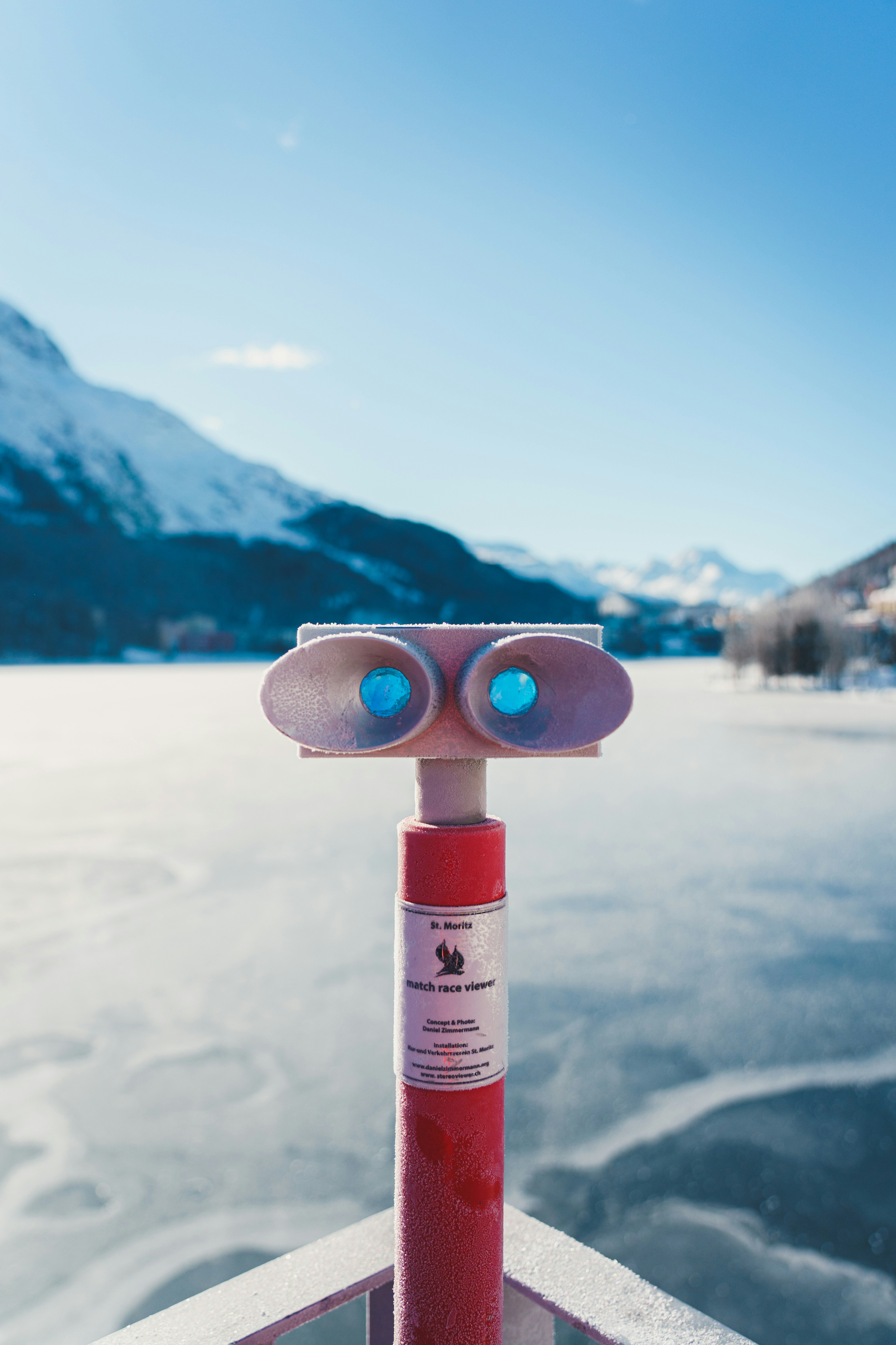 a red fire extinguisher sitting on top of a metal pole