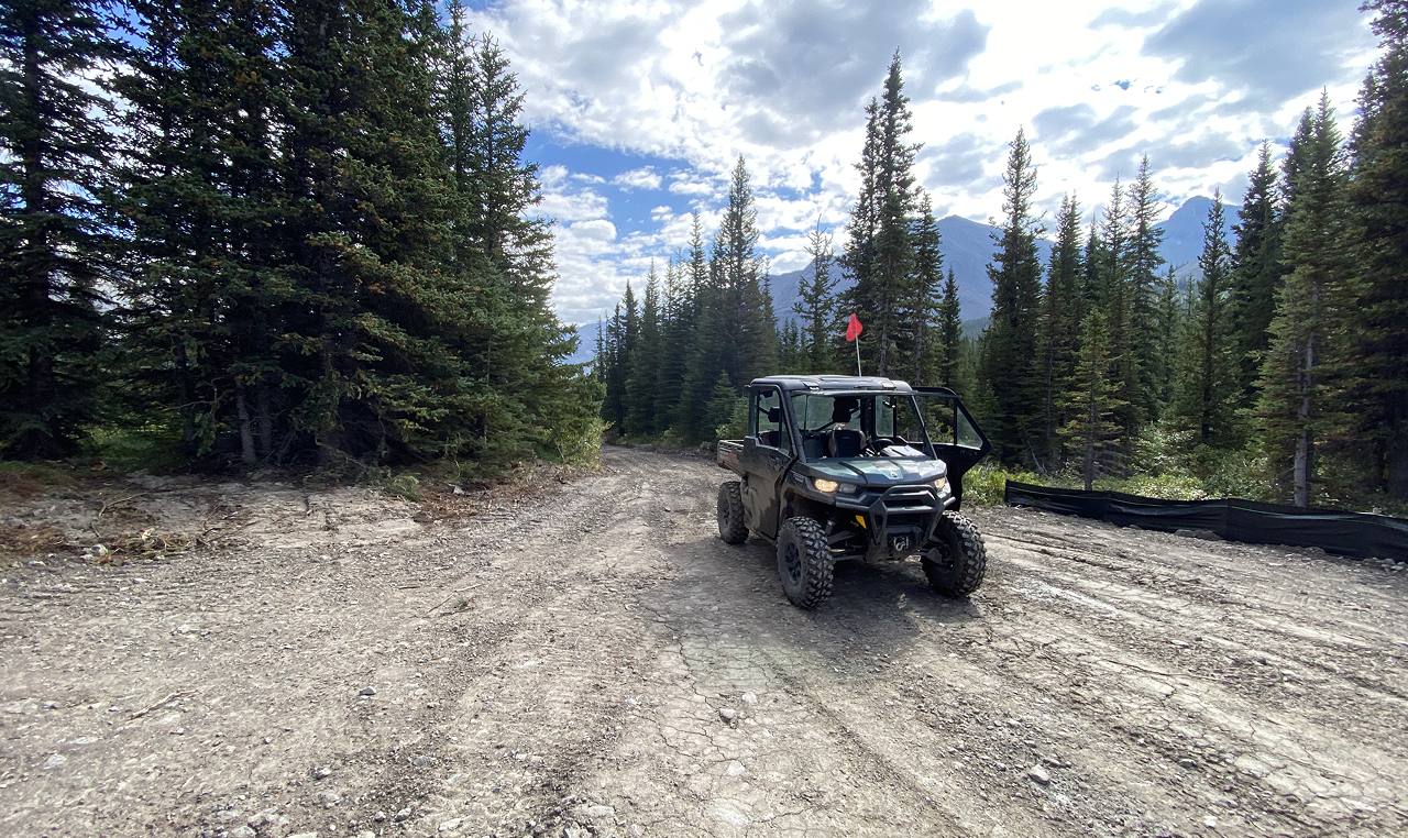 OHV on refurbished gravel trail through forest at Cardinal River Headwaters in Whitehorse Wildland Provincial Park
