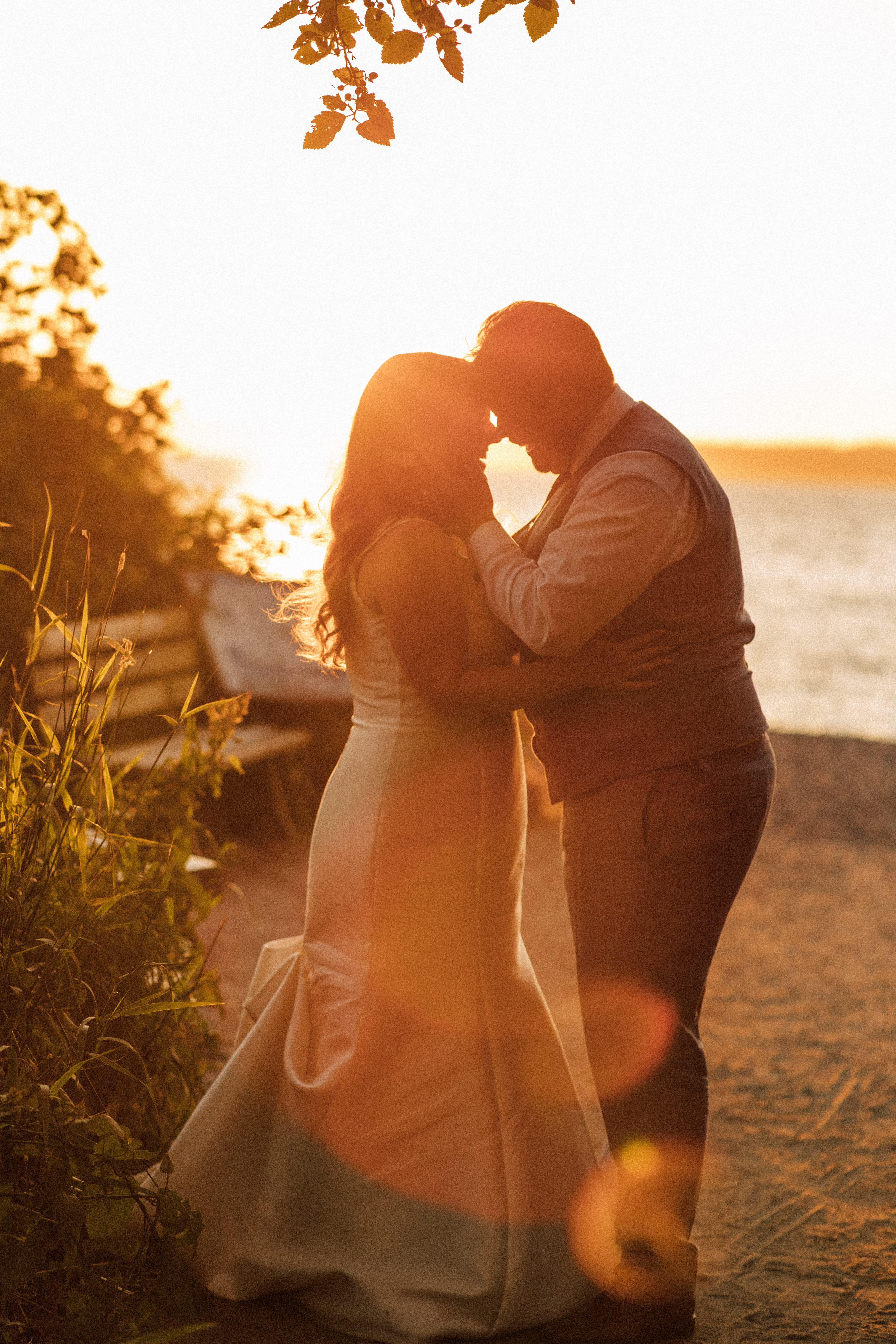 man and woman on beach at sunset