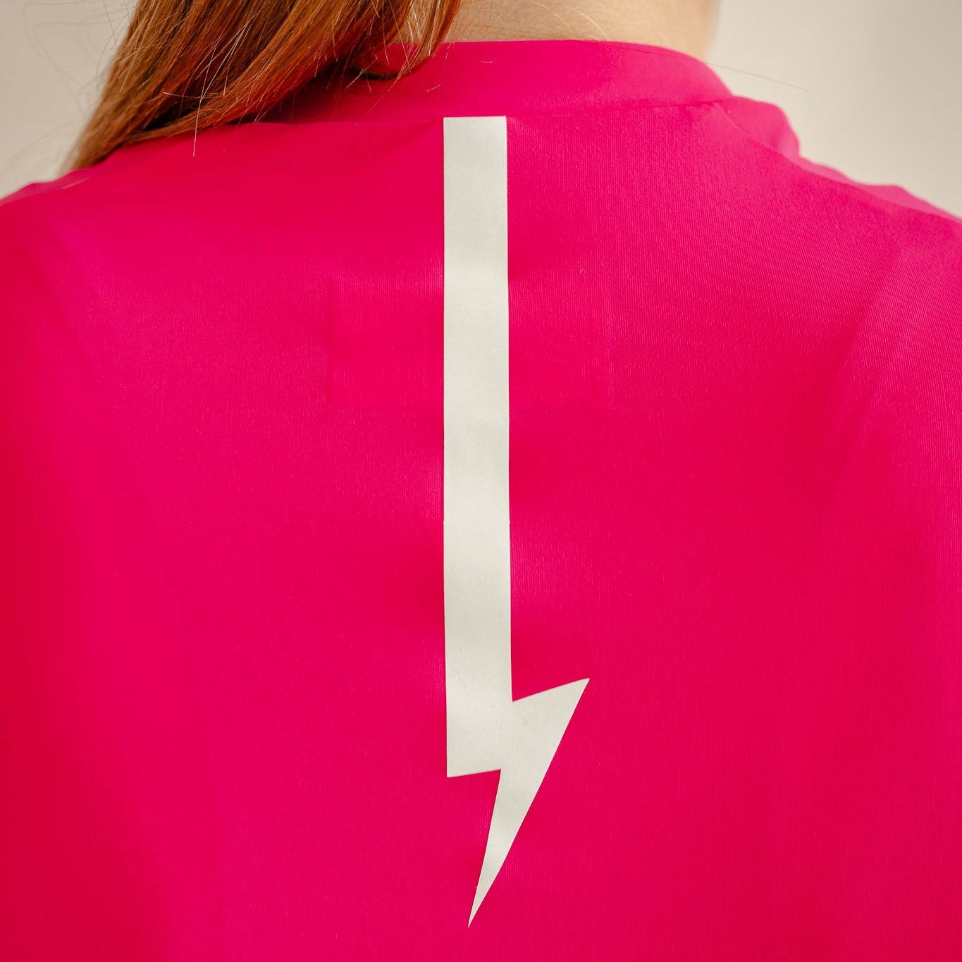 Soleil cycling jersey in hibiscus, reflective lightning bolt detail on back