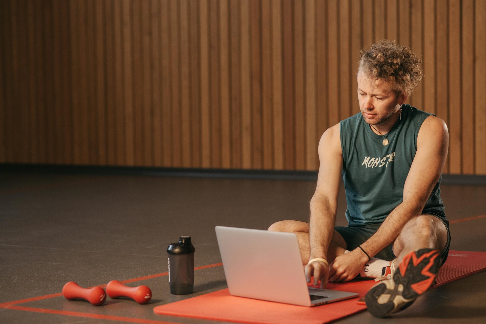 person sitting on the floor using laptop