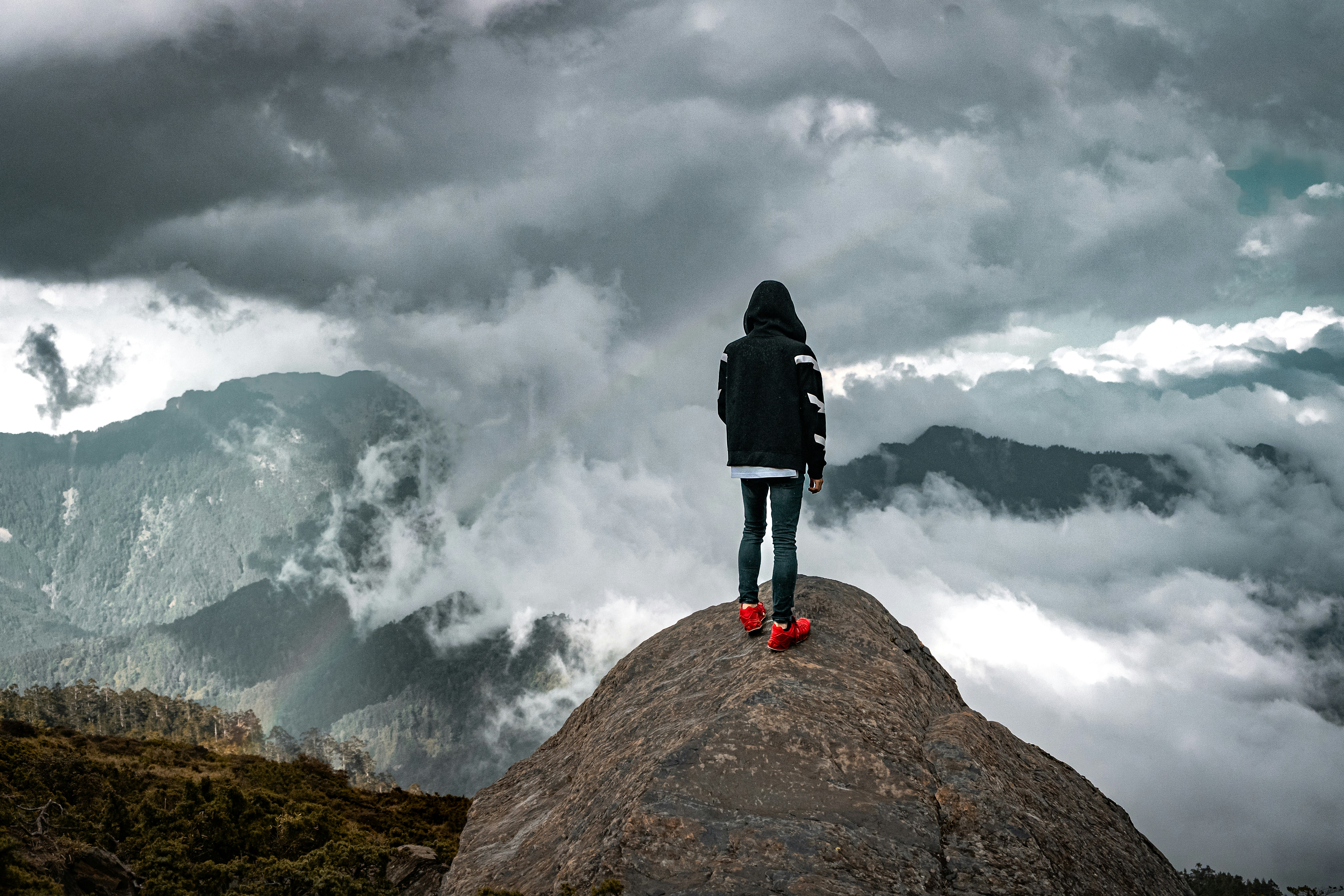 a person standing on top of a large rock