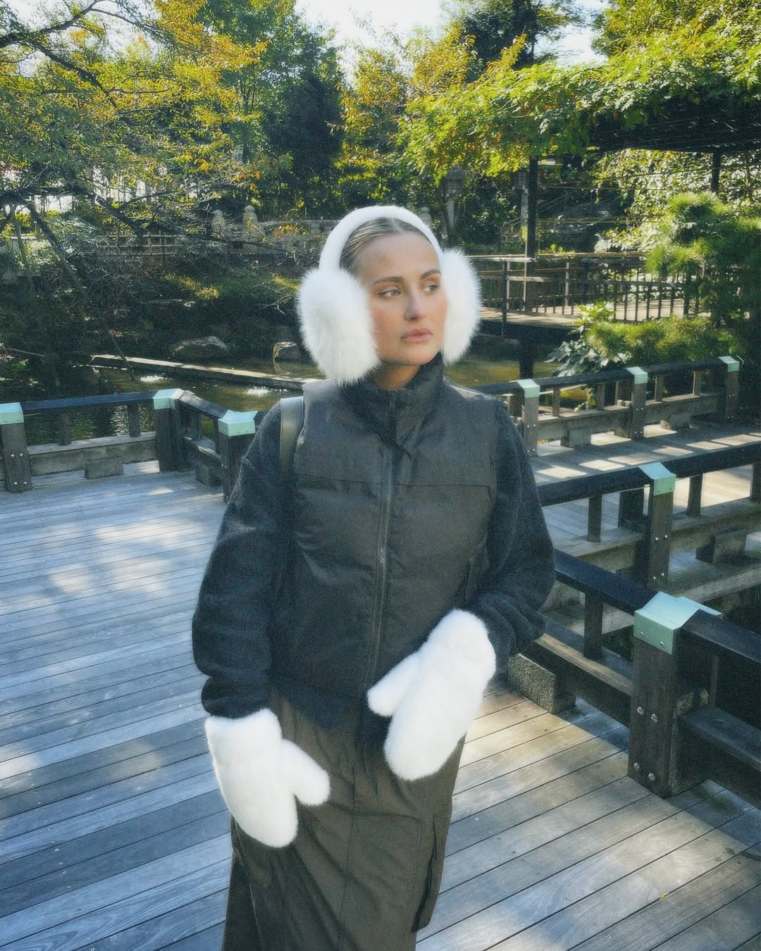 woman with white ear muff and winter coat 