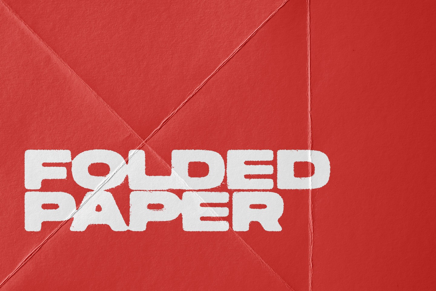 Detailed view of a folded paper texture with sharp creases on a red background