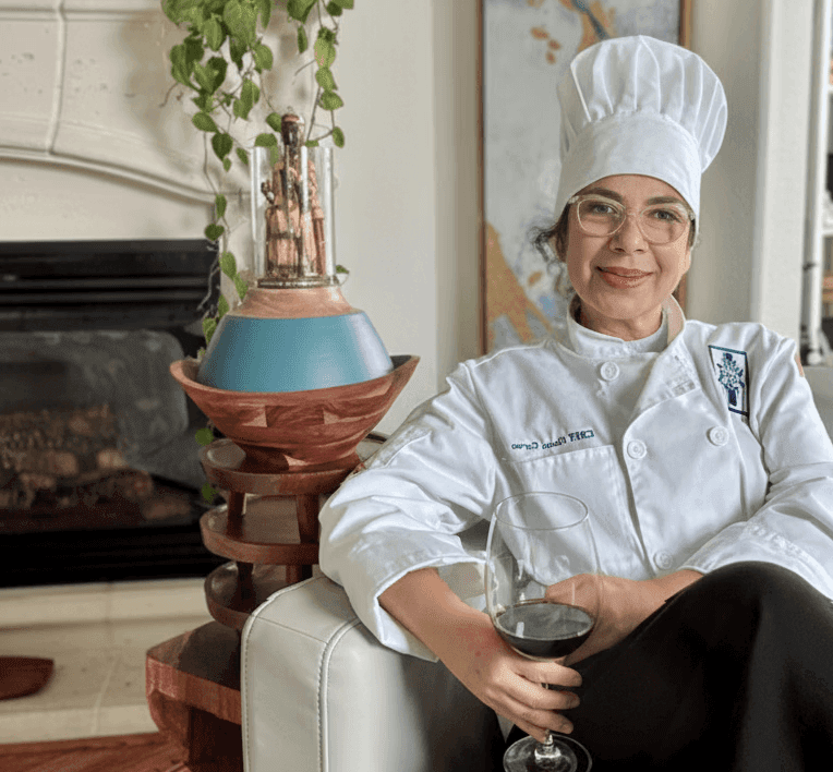 Chef Iliana Stone, a professional private chef in Houston, smiling in a modern kitchen.