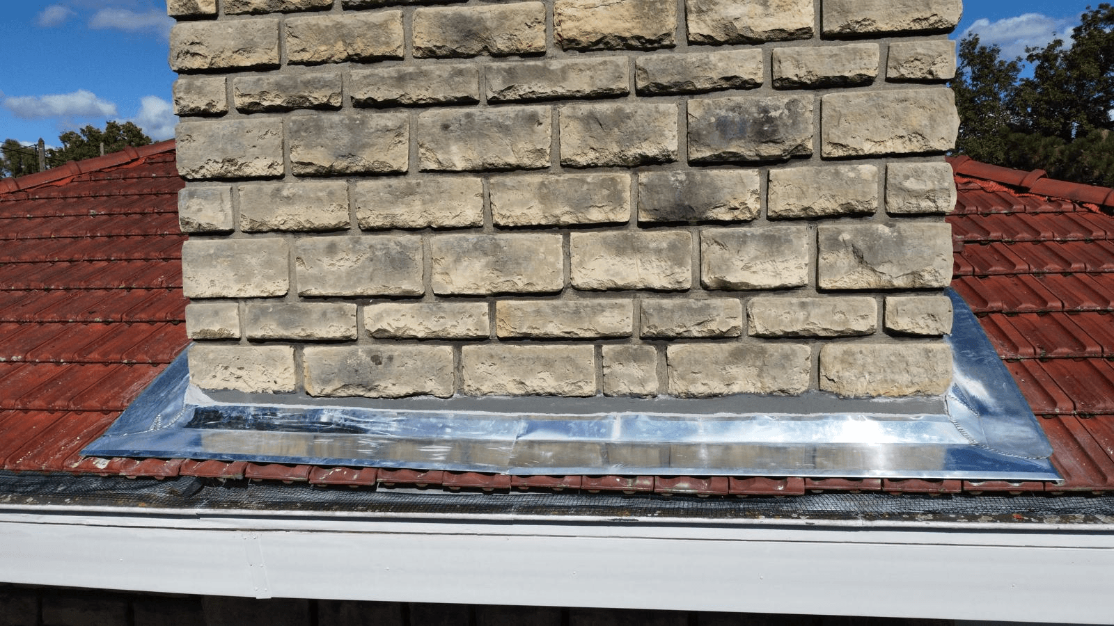 two men working on the roof of a house