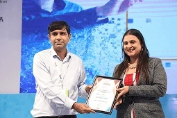 Pic of founder collecting ET Education Symposium award
