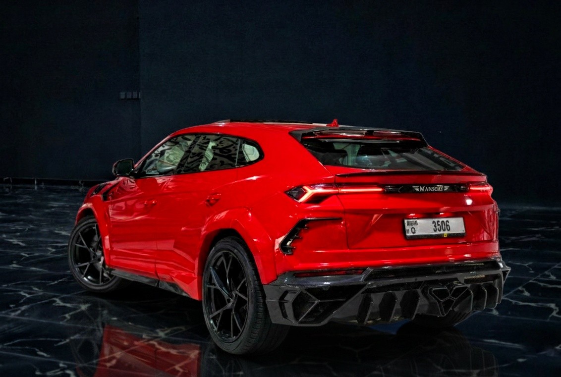 Rear view of red Lamborghini Urus Mansory style luxury SUV rental in Dubai